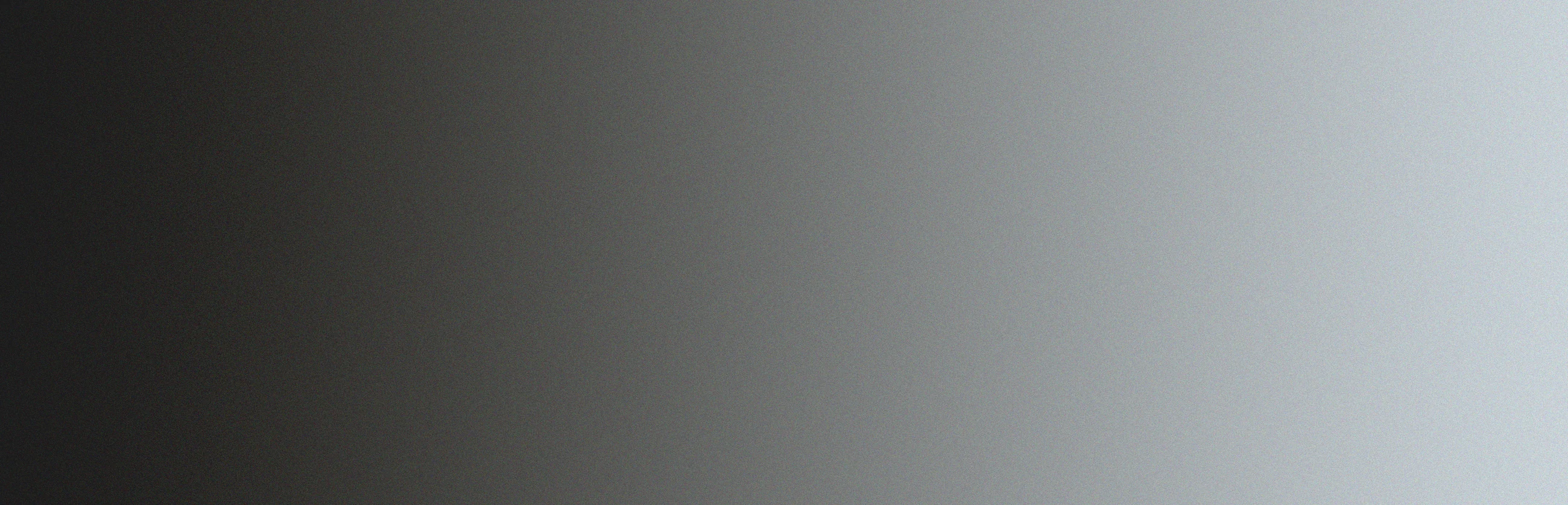 A gradient background transitioning from black on the left to light gray on the right.